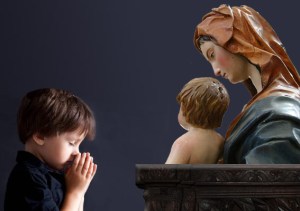Niño rezando ante imagen de la Virgen